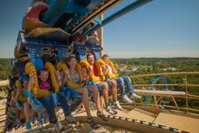 Group of people enjoying an outdoor thrill ride in a fun and family-friendly atmosphere